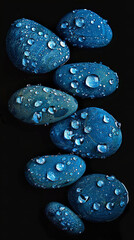 elegant many blue pebbles and water droplets isolated on black