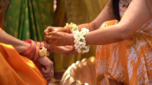 The ceremonial binding of Kalava during Haldi symbolizes unity and blessings. High quality Full HD footage