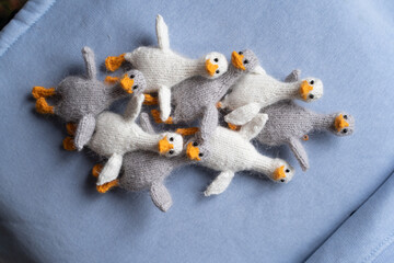 Knitted geese toys on a blue background - 743657228