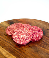 burger patties on wooden board