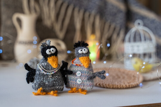 Knitted crow toys with decorations and shiny objects