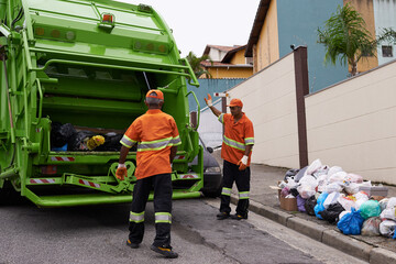 Trash, people and working with garbage truck for waste management, service and maintenance. Urban, cleaning and men outdoor with industrial sanitation, collection of rubbish and infrastructure