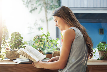 Book, coffee shop and relax with woman reading at table as customer for break, caffeine or...