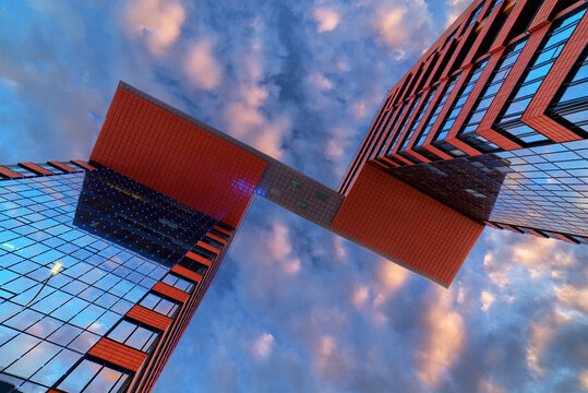 Modern glass building (business center with offices) in Novosibirsk city (Russia). Sunset cloudy dramatic sky on background.
