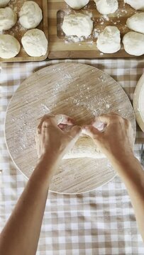 Woman in colorful apron prepares traditional stuffed food. This is a step-by-step recipe for cooking dough, panzerotti and baked or pastry products. Handmade concept​
