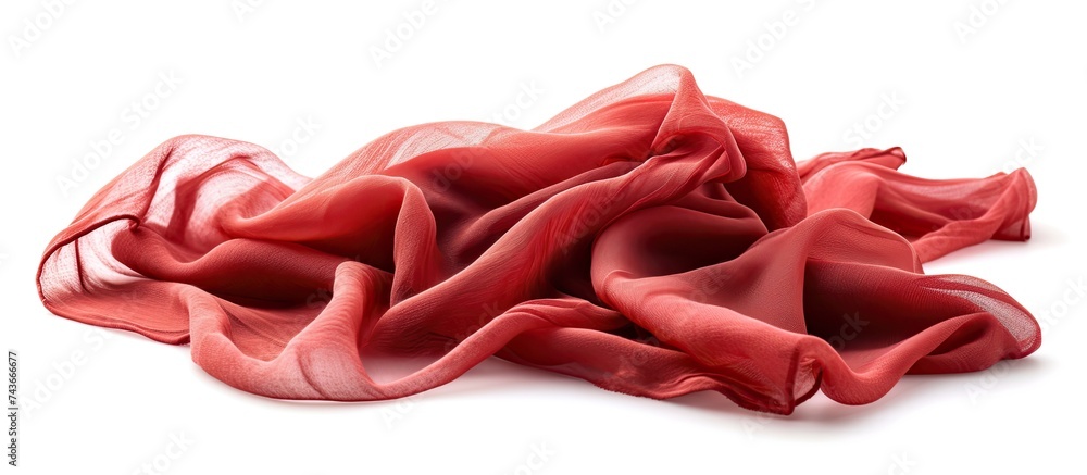 Poster a collection of vibrant red fabric piled neatly on a clean, white tabletop, creating a striking cont
