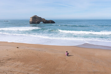 Man sitting and relaxing on Biarritz Beach - obrazy, fototapety, plakaty