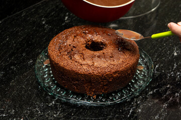 chocolate cake being prepared over a marble background