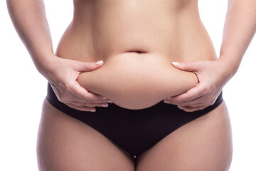 Beautiful female figure with belly fat. Excess weight and cosmetology. Close-up. Front view....