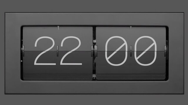 Flip clock quickly flips. Retro flip clock changing from 21:59 to 22:00. Slow motion. Close up.