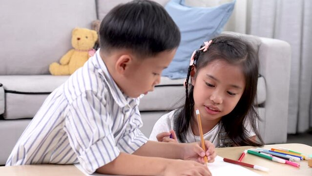 Happy preschool kids enjoy carefree bonding relationships exploring learning digital technology on smartphone, sibling brother and sister laughing playing drawing together at home weekend activities