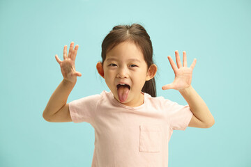 Playful and Lovely Asian Ethnicity Child Girl cheerfully showing opening hands up, sticking out...
