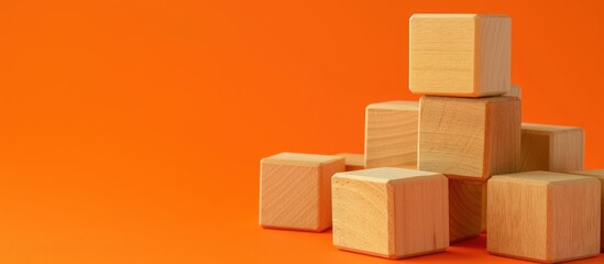 A stack of wooden blocks with service provider concepts displayed on them is placed against a vibrant orange backdrop. The blocks symbolize different business services and stand out against the