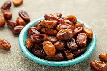 Fresh dates on plate on grey background. Close up