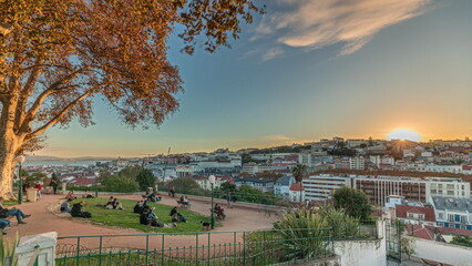 Panorama showing Jardim do Torel timelapse with views to the city center of Lisbon during sunset....