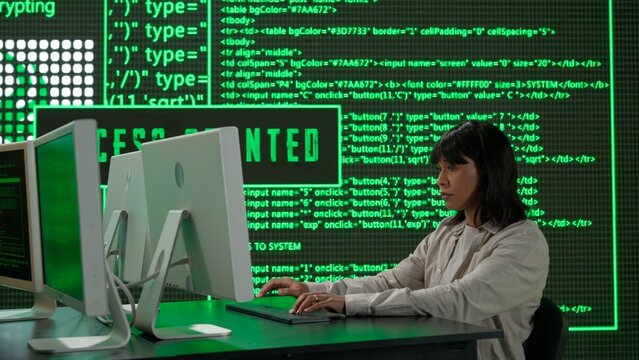 IT specialist against big digital screen. Back view african american woman programmer works on computer, screen digital code data process.