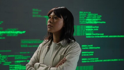 IT specialist against big digital screen. African american woman engineer scientist in front of the screen with digital code software data.