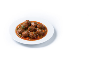 Meatballs, green peas and carrot with tomato sauce isolated on white background. Copy space