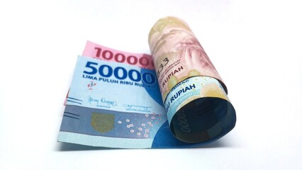 a roll of Indonesian banknotes worth IDR 100,000 and IDR 50,000. Indonesian currency rupiah isolated on white background