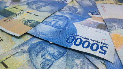 Indonesian currency worth IDR 50,000 fills the frame. Backgrond concept