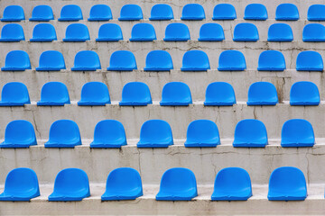 Plastic blue seats rows on street auditorium or stadium. No people