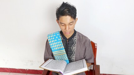 Asian Muslim man is reading the al-quran