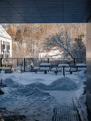 Snowy yard and outdoor furniture in winter