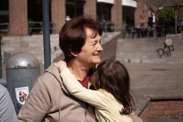 Elderly woman with her granddaughter in the city center of Dusseldorf