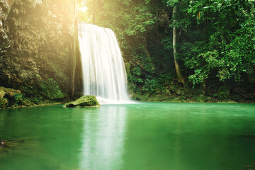 Waterfall in the green forest and golden light at Erawan National Park, Kanchanaburi province,...