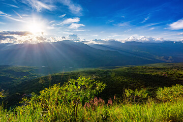 Sunset view from the most known El Camino Real trail in Barichara, Colombia. The trail is surrounded by lush greenery and offers stunning views of the surrounding hills of Andes mountains. - 743734485