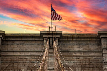 Sunrise or sunset photo of the Brooklyn Suspension Bridge linking the boroughs of Manhattan and...