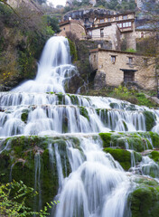 Fototapeta na wymiar Orbaneja del Castillo. The waterfall of Orbaneja del Castillo in the province of Burgos.
