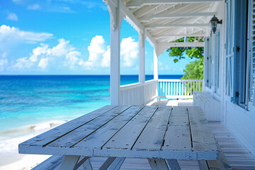 Beachfront veranda with white wooden table against a blue ocean backdrop