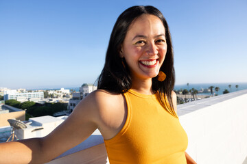 Candid Photo of An Attractive Smiling South American Woman in the Rooftop in the Morning, Los...