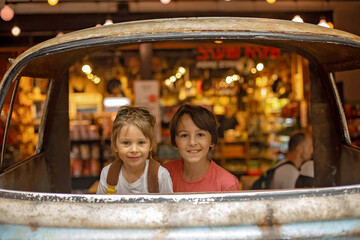 Family with kids, enjoying the Sarona Market in Tel Aviv, Israel