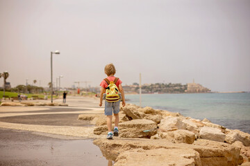 European tourist family with children, visiting Tel Aviv, Israel, enjoying day walk