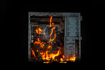 computer unit is burning with open fire and smoke from overheating, on a black isolated background