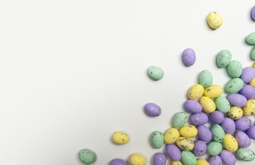 Top view of colourful easter eggs on white background. Creative easter composition, spring, copy space, flat lay.