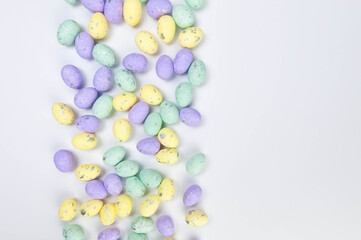 Top view of colourful easter eggs on white background. Creative easter composition, spring, copy space, flat lay.