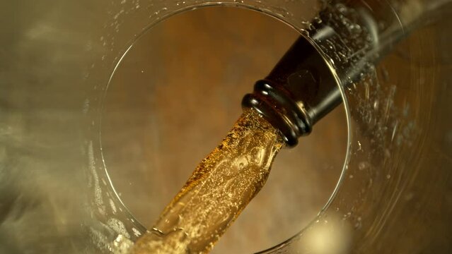 Super Slow Motion of Macro Shot of Pouring Beer drink. Unique Perspective from inside of a Glass. Filmed on High Speed Cinema Camera, 1000 fps. Speed Ramp Effect.