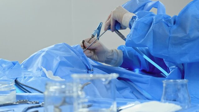 A young surgeon is performing a laparoscopic surgery.