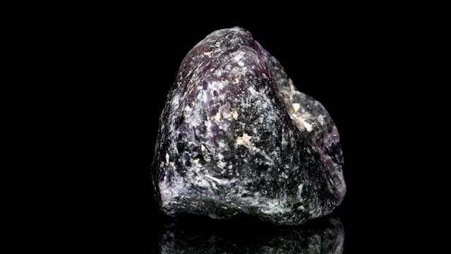 Purple Fluorite sample rotating slowly against a black background.	