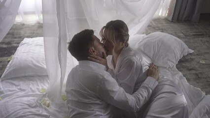 A couple sharing a romantic moment under a canopy, kissing in the darkness - Powered by Adobe