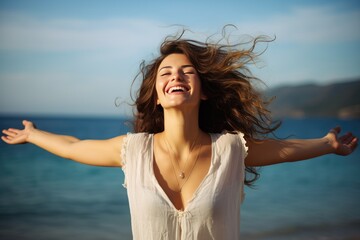 Fototapeta na wymiar Happy young woman with open arms at the beach smiling