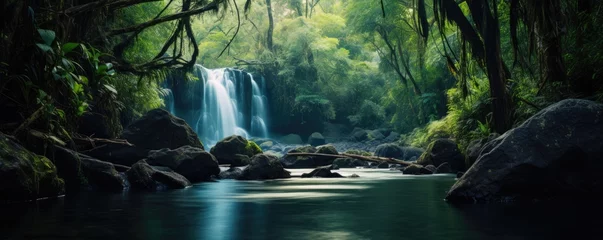 Fotobehang Amazing tropical forest with beautiful lake and fast flowing waterfall over boulders in background. © Filip