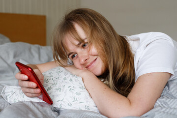 woman with phone in bed in the morning