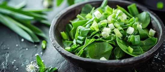 Deurstickers Healthy spring dietary food: green salad with vegetables and bear leek or wild garlic. © Emin