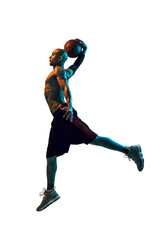Slam dunk. Full-length image of sportive young african-american male basketball player in motion with ball, jumping isolated on transparent background. Concept of sport, competition and tournament