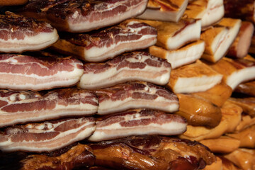 Exposed bacon and dried meat domestic products presented for sale on a farmer's market in Kacarevo village, gastro bacon and dry meat products festival called Slaninijada (bacon festival) held yearly 