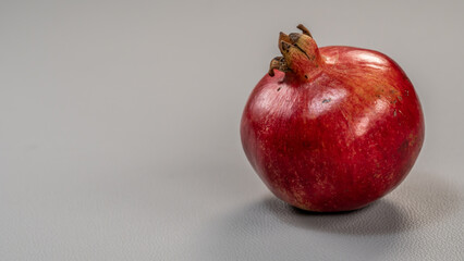 Isolated Red Pomegranate Fruit on Light Grey Background